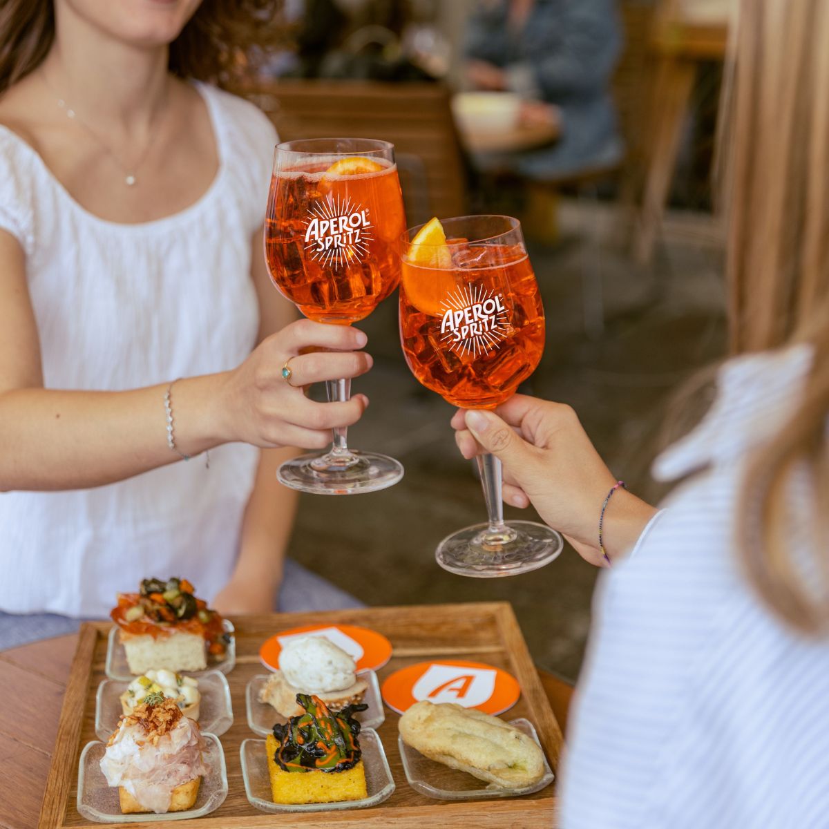 Two fans enjoying Aperol Spritz